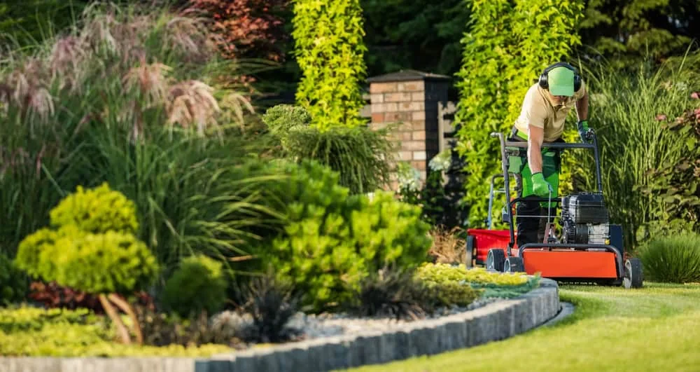 Landscaper Using Lawn Aerator Mecklenburg County North Carolina_1
